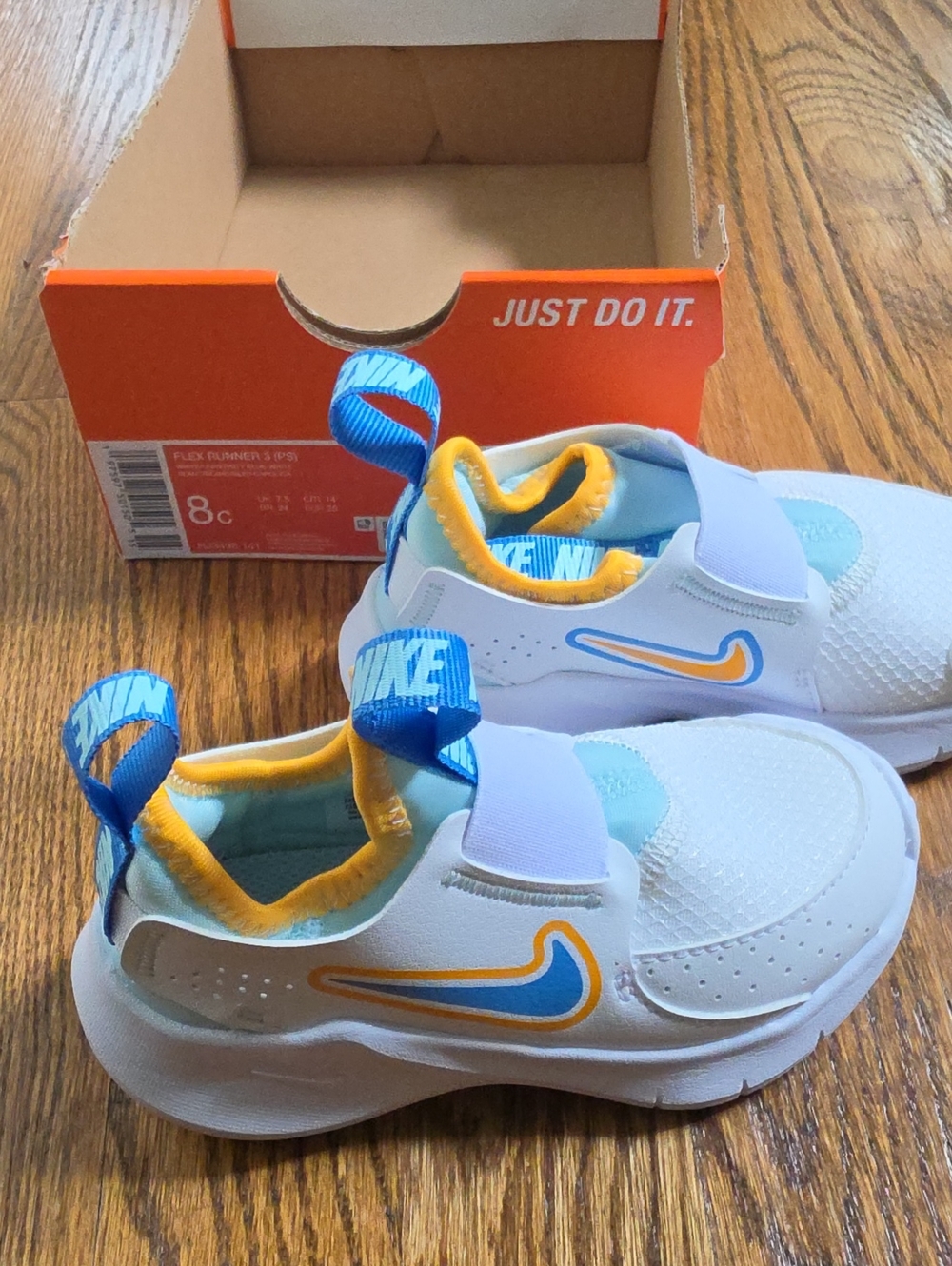 Nike Kids White Sneakers with Blue & Yellow Accents